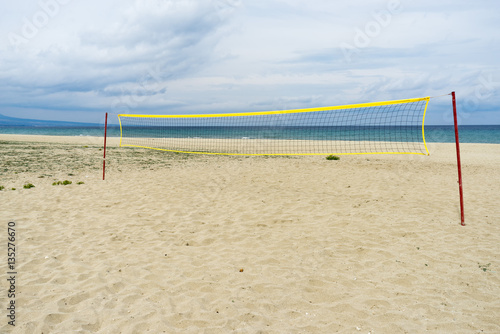 View on Mediterranean Sea sunny sand beach with volleyball net. Nei Pori village, Pieria, Greece. 
