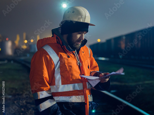 Construction worker in helmet working at night.