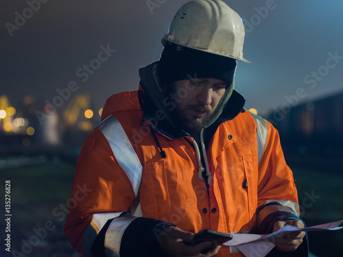 Construction worker tired and sitting asleep in the twilight. Concept of overworking