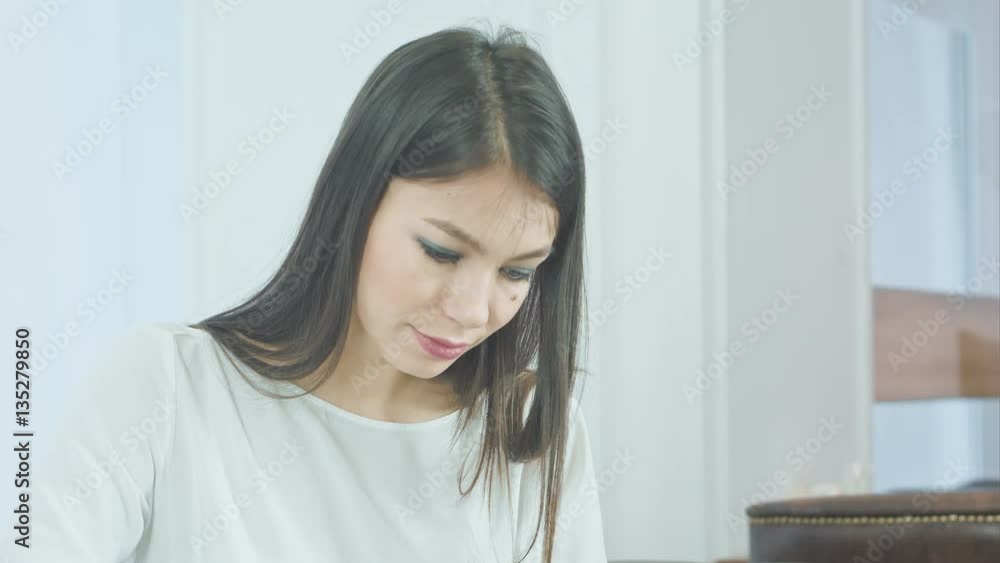 Concentrated young woman using tablet pc Concentrated young woman using tablet pc