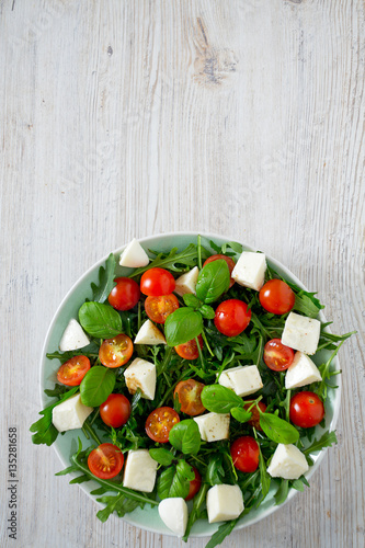 Vegetarian salad with cherry tomato, mozzarella and rucola