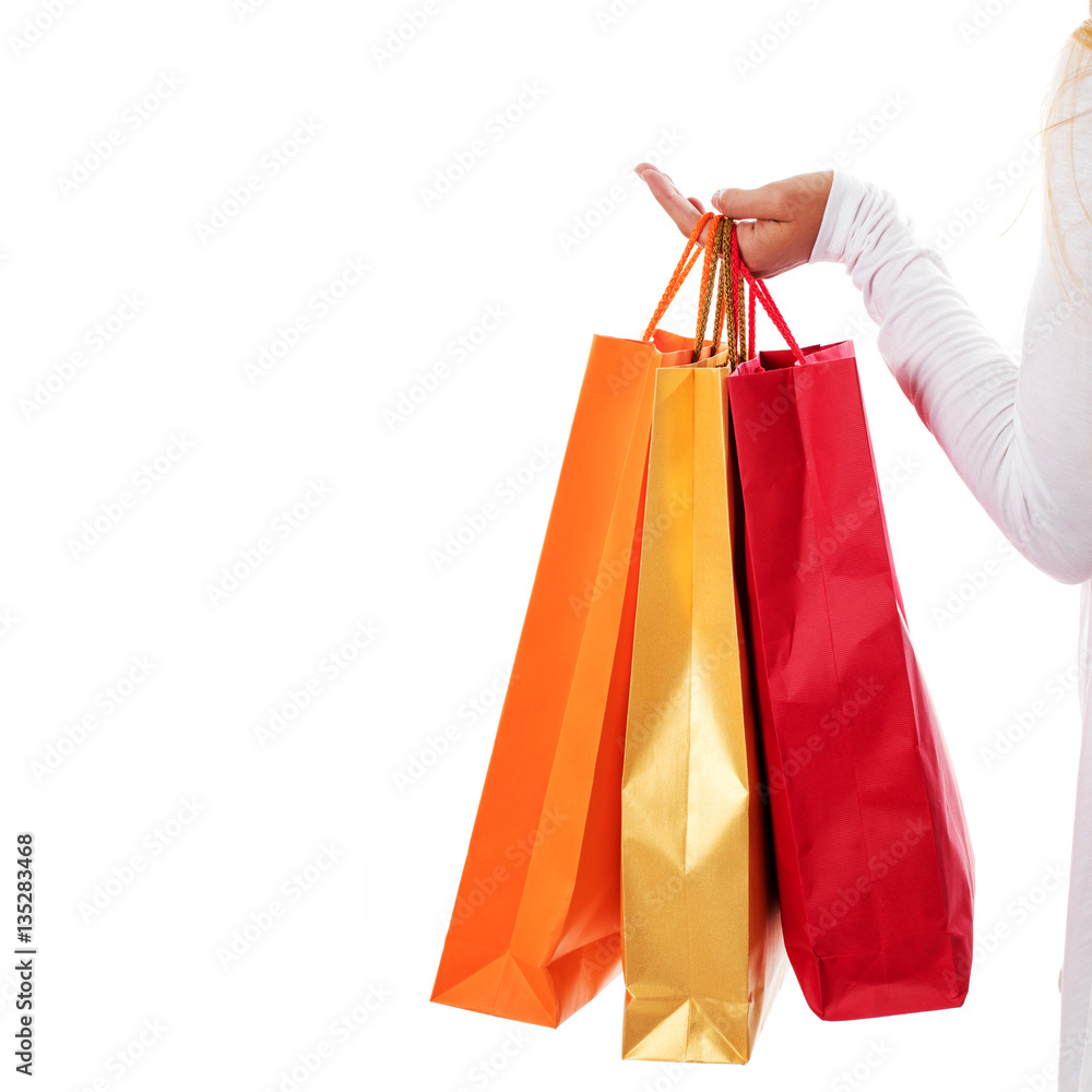 Isolated womans hand carries a shopping bag.