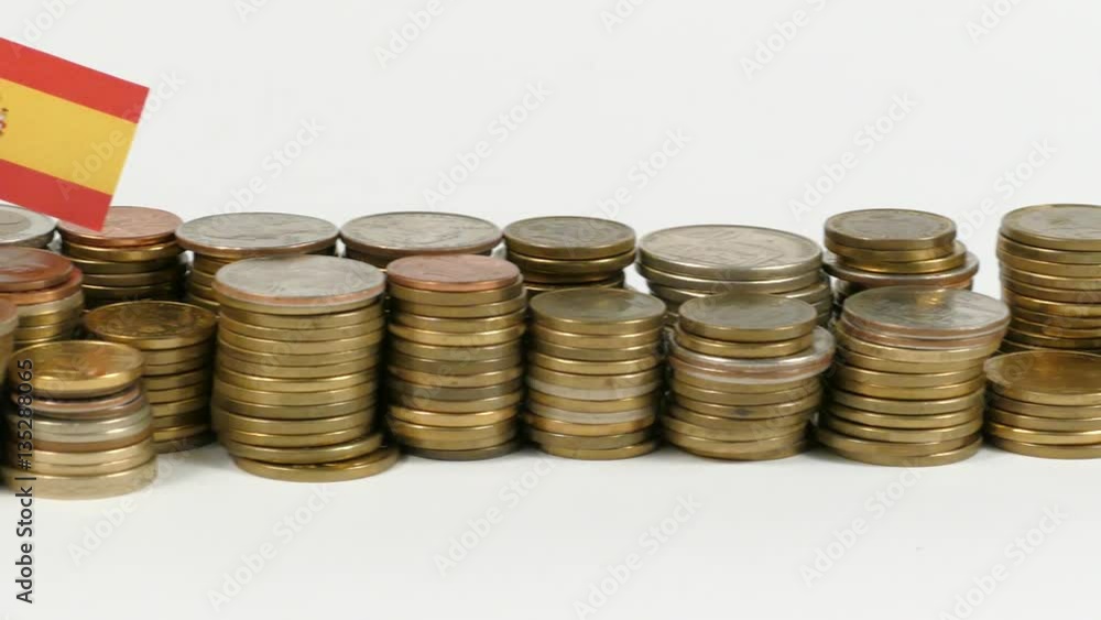 Spain flag waving with stack of money coins Spain flag waving with stack of money coins