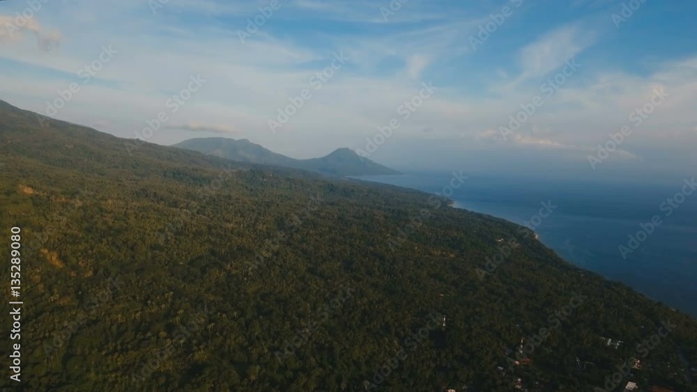 Aerial view coastline on tropical island with sea, trees, palms. Aerial footage. Mountains and hills with wild forest, sky clouds. Aerial video from flying drone of amazingly beautiful landscape with Aerial view coastline on tropical island with sea, trees, palms. Aerial footage. Mountains and hills with wild forest, sky clouds. Aerial video from flying drone of amazingly beautiful landscape with