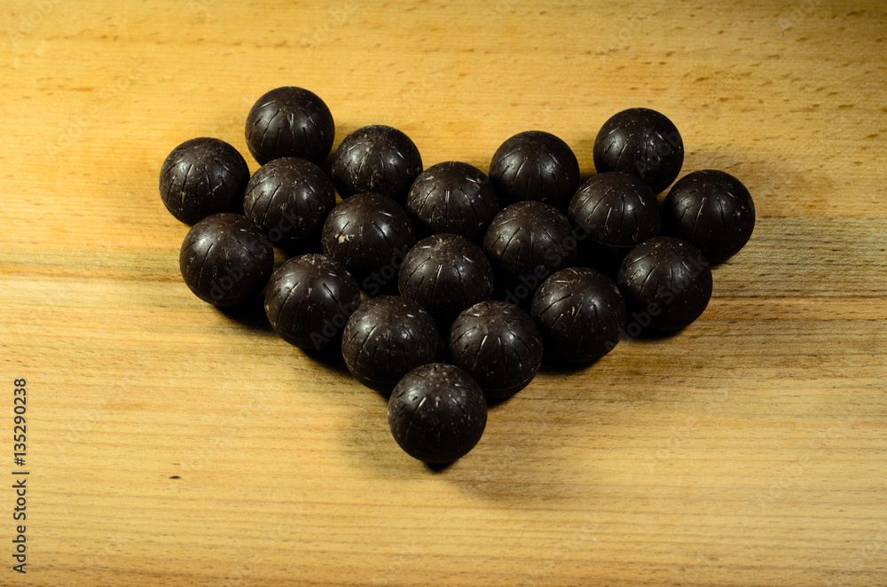 Chocolate balls lying in a form of heart