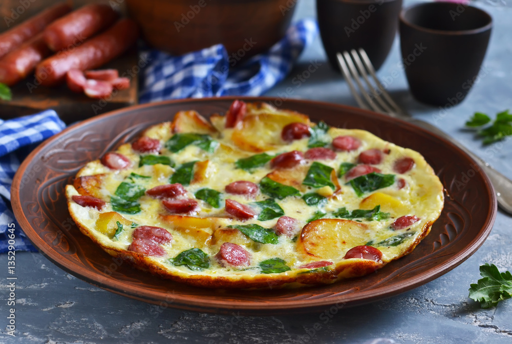 Omelet with spinach, cheese and Bavarian sausages.