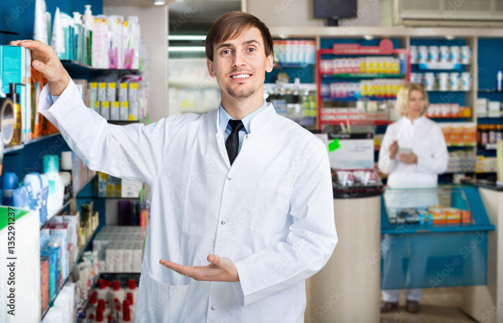 Portrait of two  pharmacists working in modern farmacy
