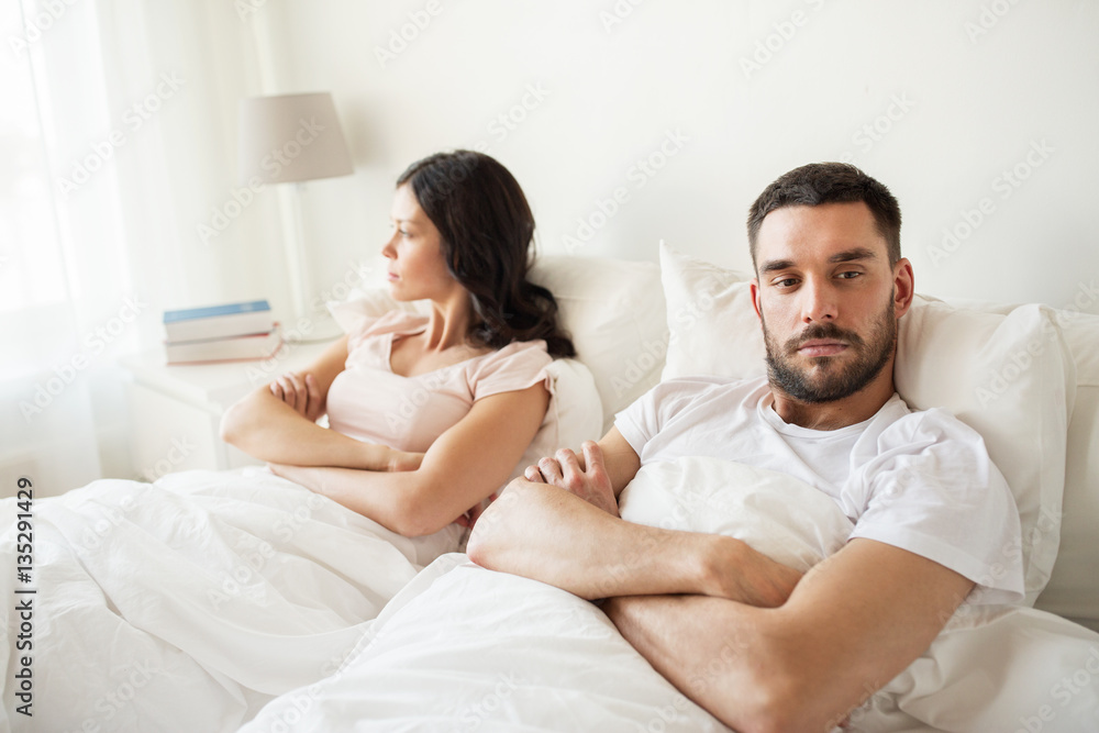 unhappy couple having conflict in bed at home unhappy couple having conflict in bed at home
