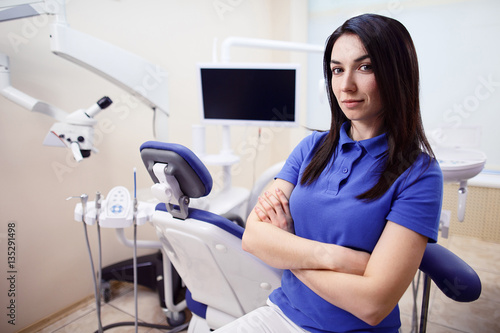 Attractive young dentist in clinic