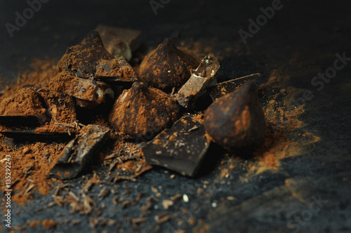Set of chocolate, truffles and cocoa on rustic background 