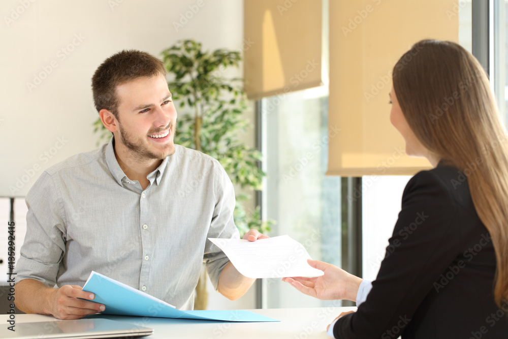 Man giving resume in a job interview Man giving resume in a job interview