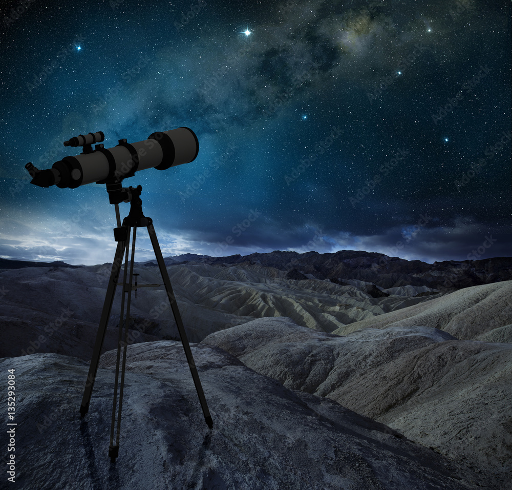 Naklejka premium telescope tripod pointing the milky way in a desert landscape