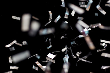 silver confetti over black background