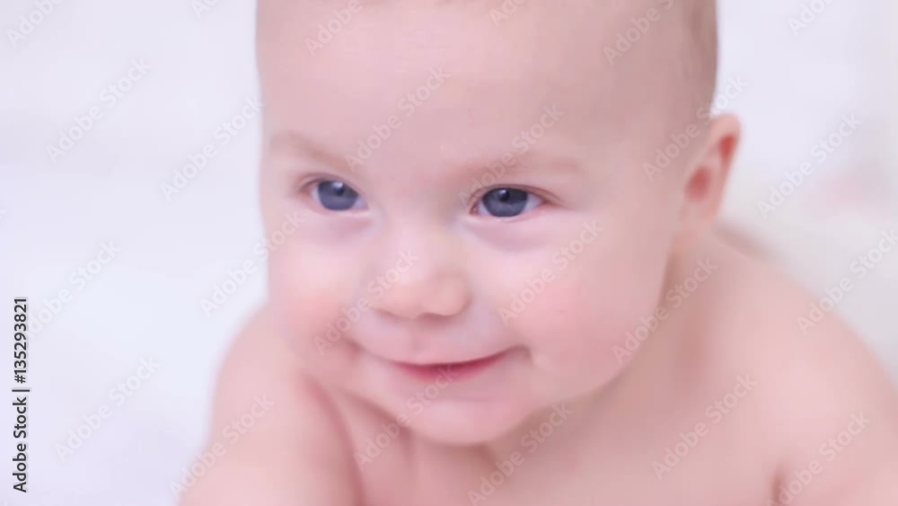 naked baby is five months old looking at the camera with his big blue eyes naked baby is five months old looking at the camera with his big blue eyes