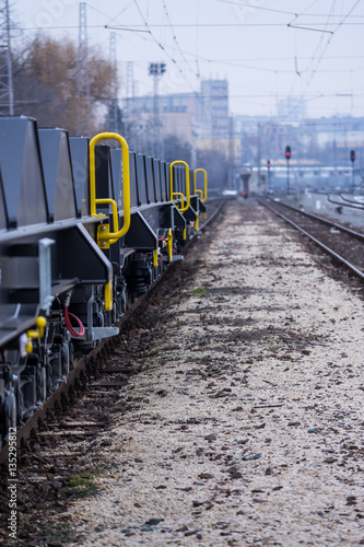 Burgas, Bulgaria - January 24, 2017 - Freight cargo train - black cars wagons - New 6-axled flat wagon - Type: Sahmmn - Model WW 604 A- Transvagon AD photo