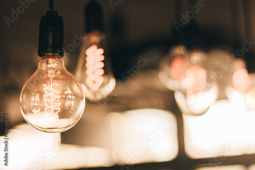 Glow old vintage ligth bulb with vintage filter (selective focus)