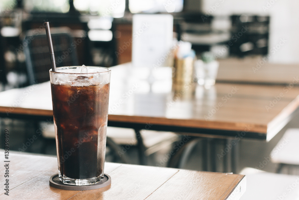 Cold black coffee on the table in the coffee shop with vintage Cold black coffee on the table in the coffee shop with vintage