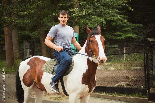 Portrait of happy man riding horse