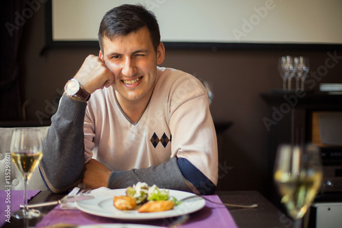 handsome man waiting for a girl in a restaurant