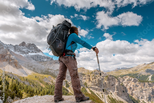 hiker with backpack standing on top of mountain