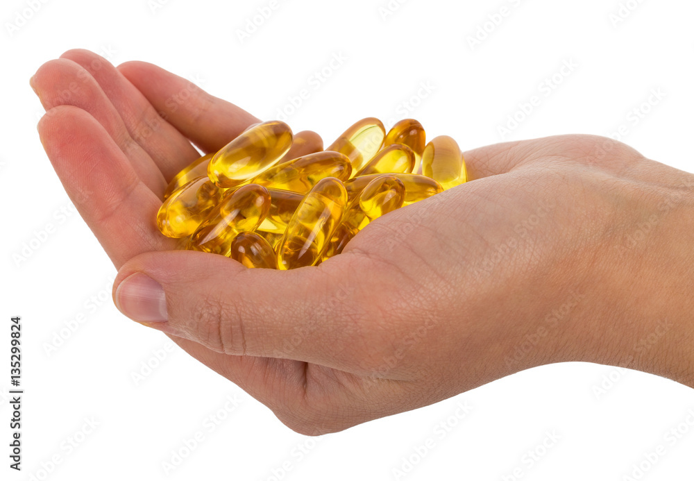 omega 3 capsules in hand omega 3 capsules in hand
