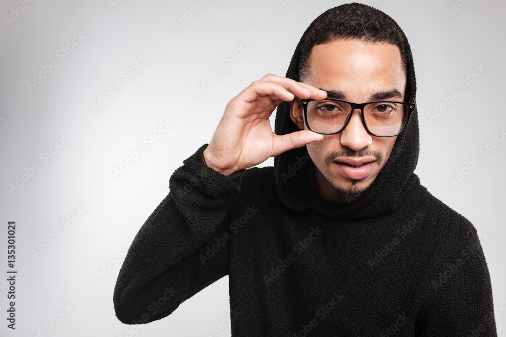 Handsome african american young man in glasses and black hoodie Handsome african american young man in glasses and black hoodie