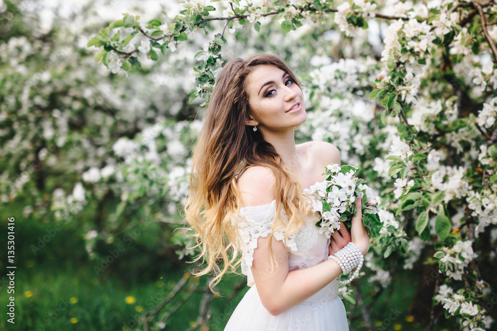 portrait of a beautiful girl in the apple orchard