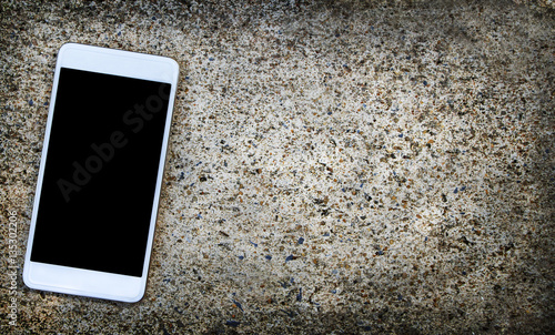 Mobile phone on cement floor