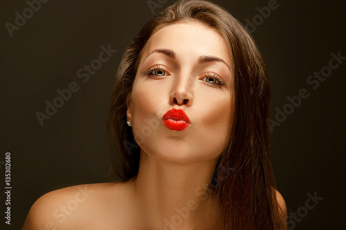 portrait of a beautiful girl sends an air kiss
