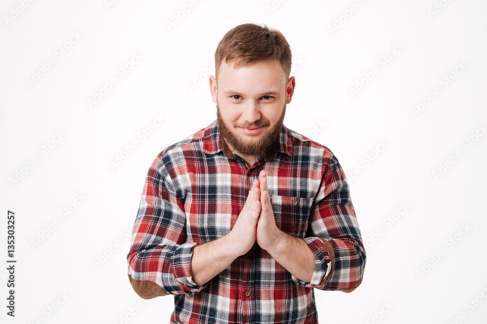 Bearded man in shirt holding hands in pray gesture Bearded man in shirt holding hands in pray gesture