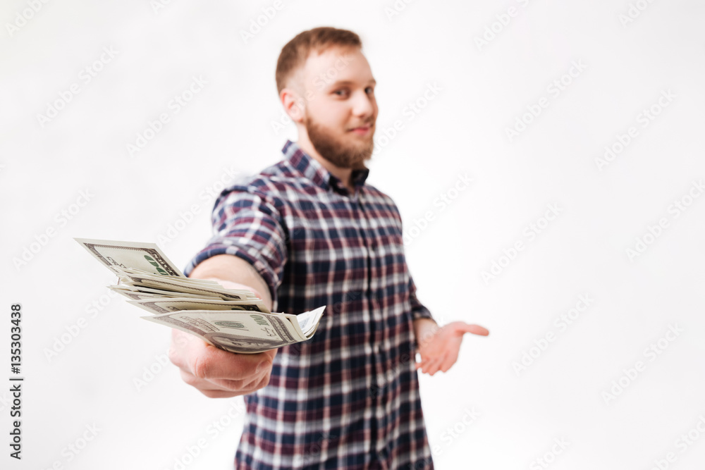 Bearded man in shirt showing money at camera Bearded man in shirt showing money at camera