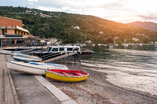 Water, boats and hill. Town buildings on the shore. Spend summer close to nature.