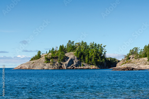 Rocky island with pine trees at the north shore of Lake Superior