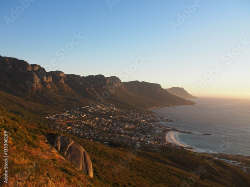 Table Mountain national park view near city and the beach with sunset in Camps Bay, Cape Town, South Africa. Take from Lion's Head mountain.