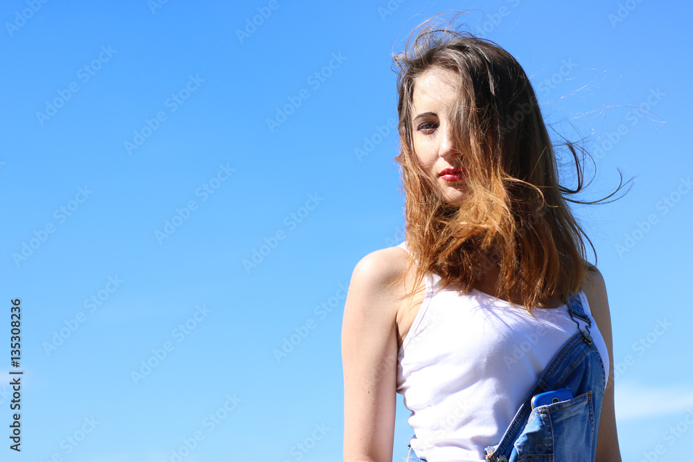 Seductive young woman on a windy day