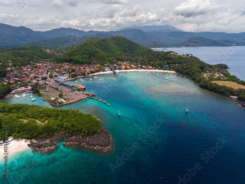 Aerial view of the tropical bay with marine port and town named Padang Bai, island of Bali, Indonesia © Dudarev Mikhail