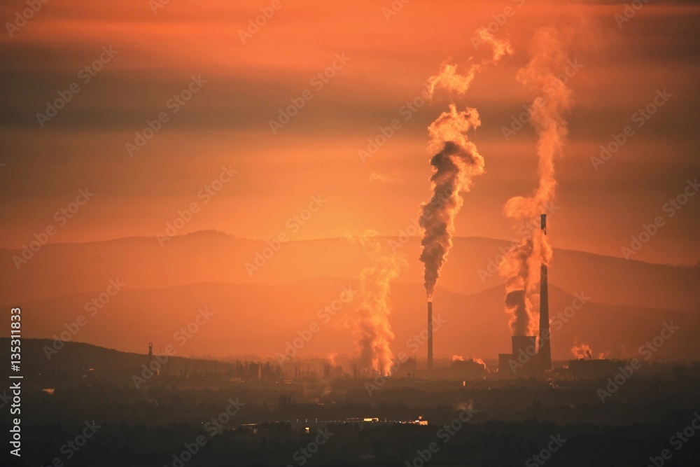 Smog hell - sunset. View from afar the city and a factory chimney with lots of smoke and smog. Europe, landscape Slovakia, Novaky. Chemical factory. Abstract. Global warming of the earth.
