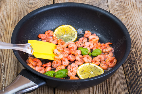 Small shrimp with lemon in a frying pan