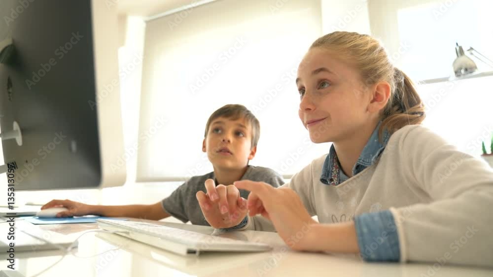 Kids in computer lab working on desktop computer Kids in computer lab working on desktop computer