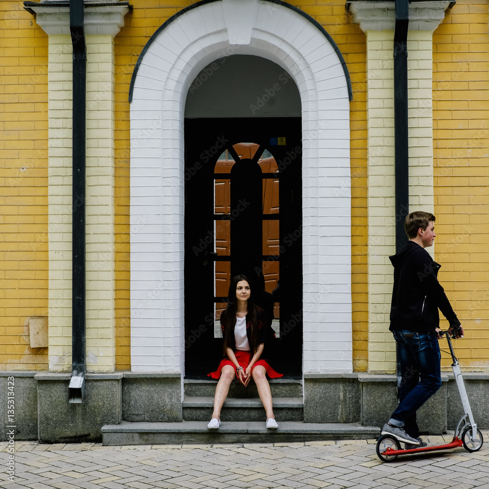 man and woman travel on scooters