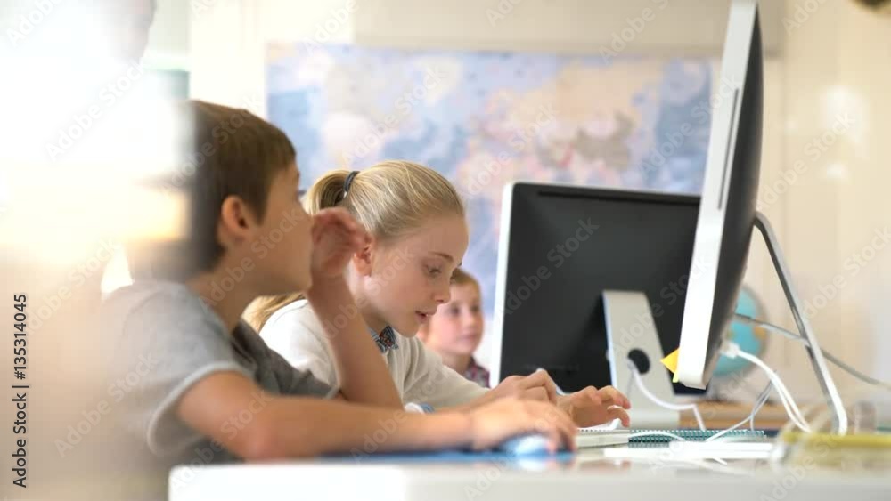 Teacher with school kids in computer laboratory Teacher with school kids in computer laboratory