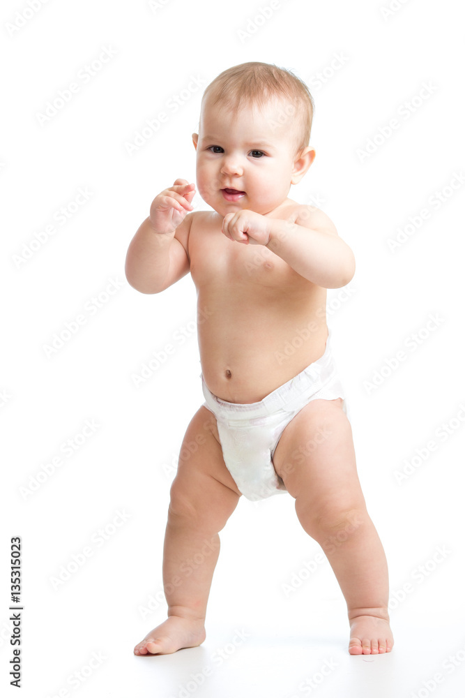 Cute smiling baby learning to walk. Kid weared diaper Isolated on white background. Cute smiling baby learning to walk. Kid weared diaper Isolated on white background.
