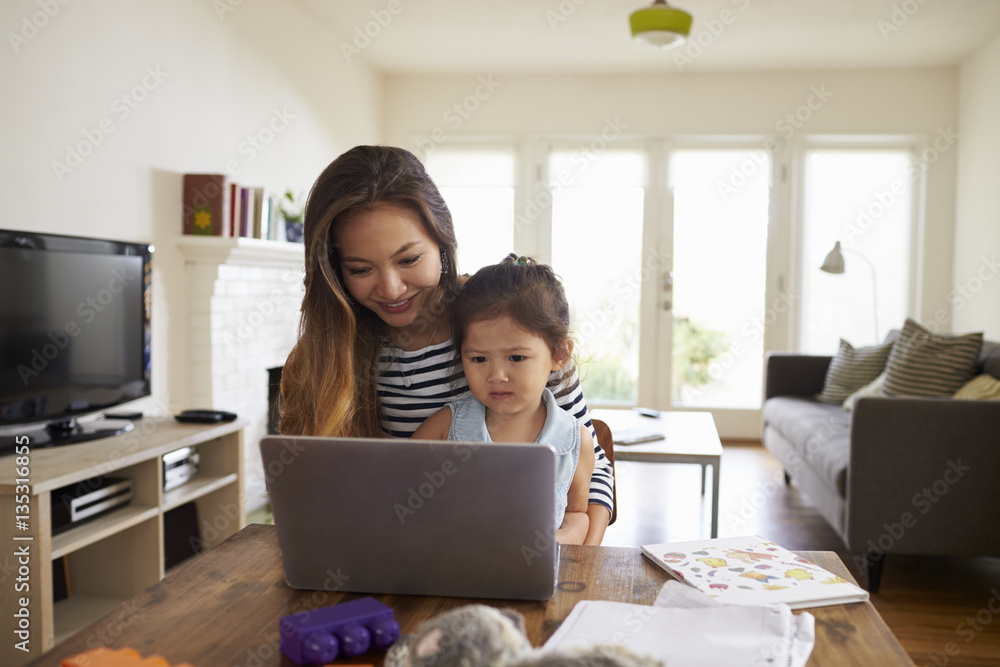 Mother And Daughter Using Laptop At Home Together Mother And Daughter Using Laptop At Home Together