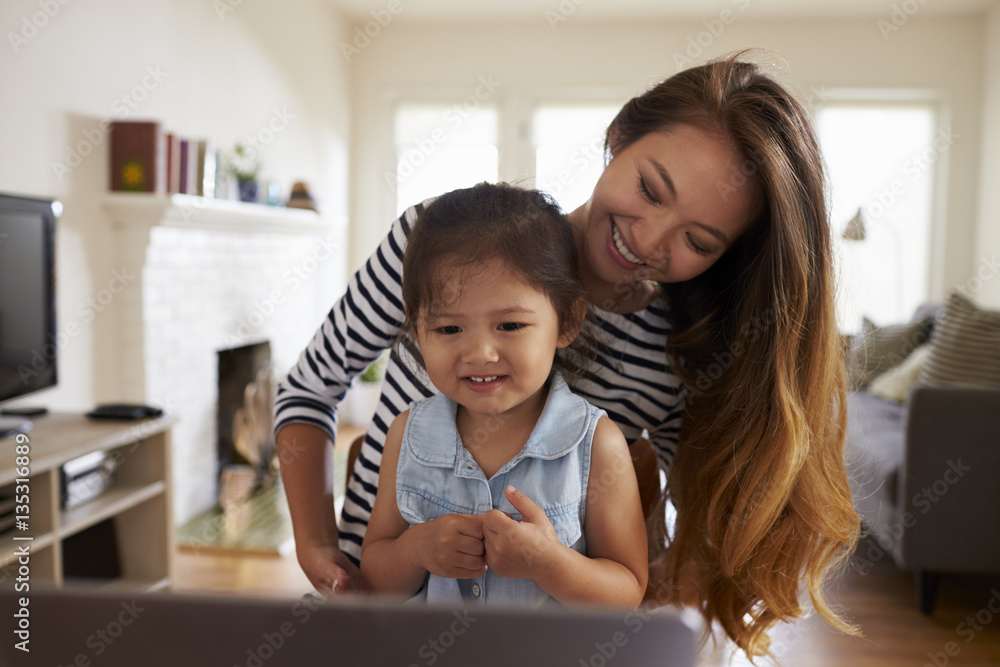 Mother And Daughter Using Laptop At Home Together Mother And Daughter Using Laptop At Home Together