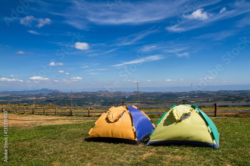 Fototapeta Naklejka Na Ścianę i Meble -  Tent on a grass under white clouds and blue sky.