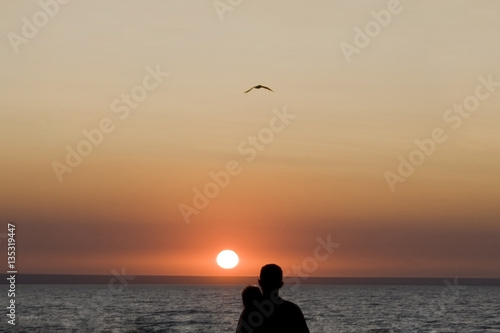 Silhouette man and woman again sunset