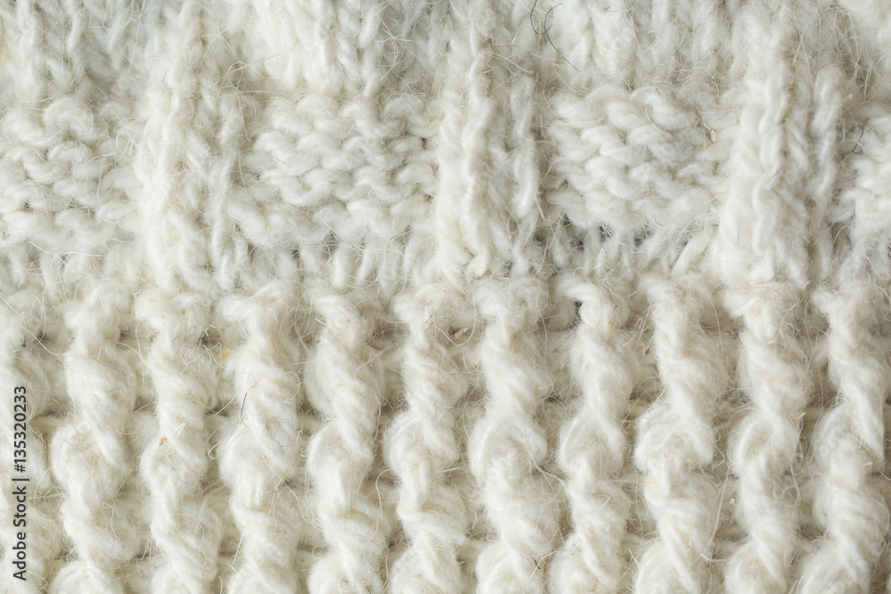 Knit texture of white wool knitted fabric with cable pattern as Knit texture of white wool knitted fabric with cable pattern as