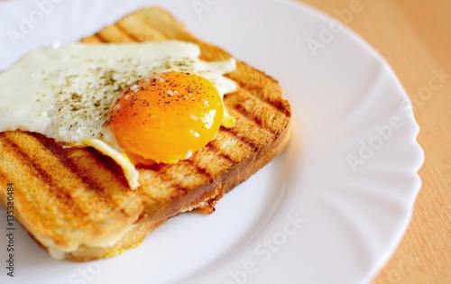 Ham and cheese toast with fried egg on top.