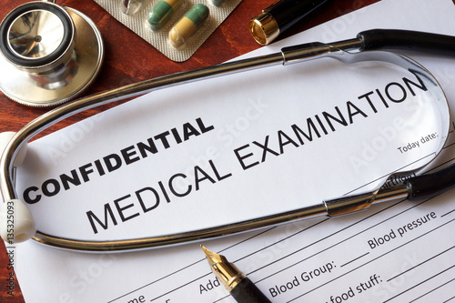 Medical confidentiality concept. Medical examination form on a table.