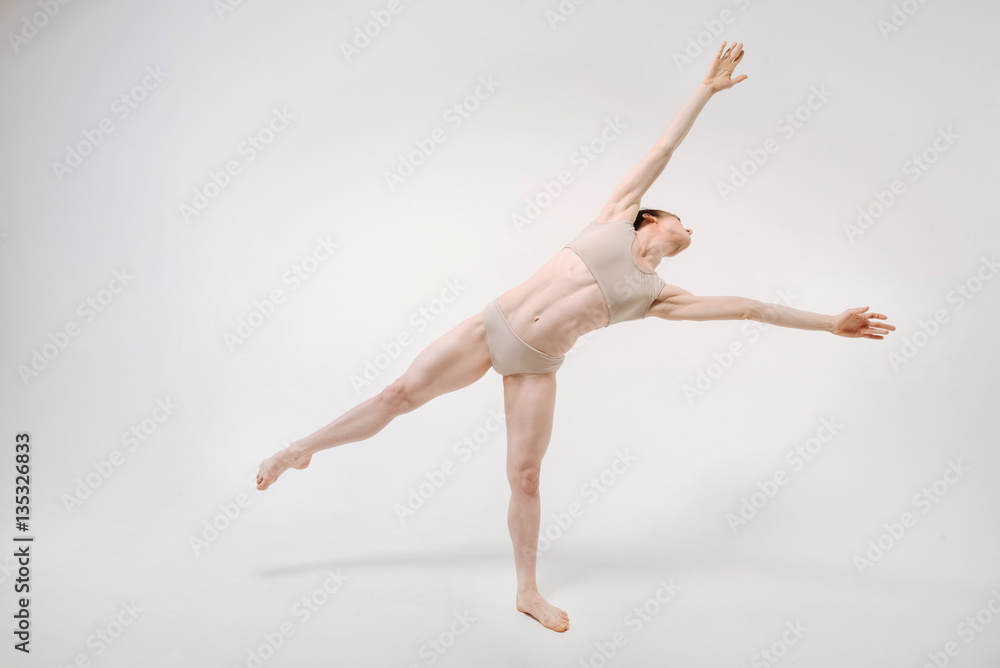Obraz premium Graceful young ballet dancer stretching in the studio